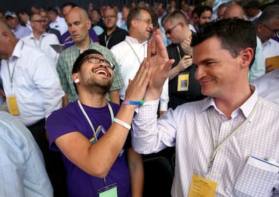 Chris Petallano, a member of the San Francisco Gay Men's Chorus, high fives Ian Christensen, with the Mormon Tabernacle Choir, during the Mormon Tabernacle Choir's soundcheck at the Shoreline Amphitheatre in Mountain View, Calif., on Monday, June 25, 2018
