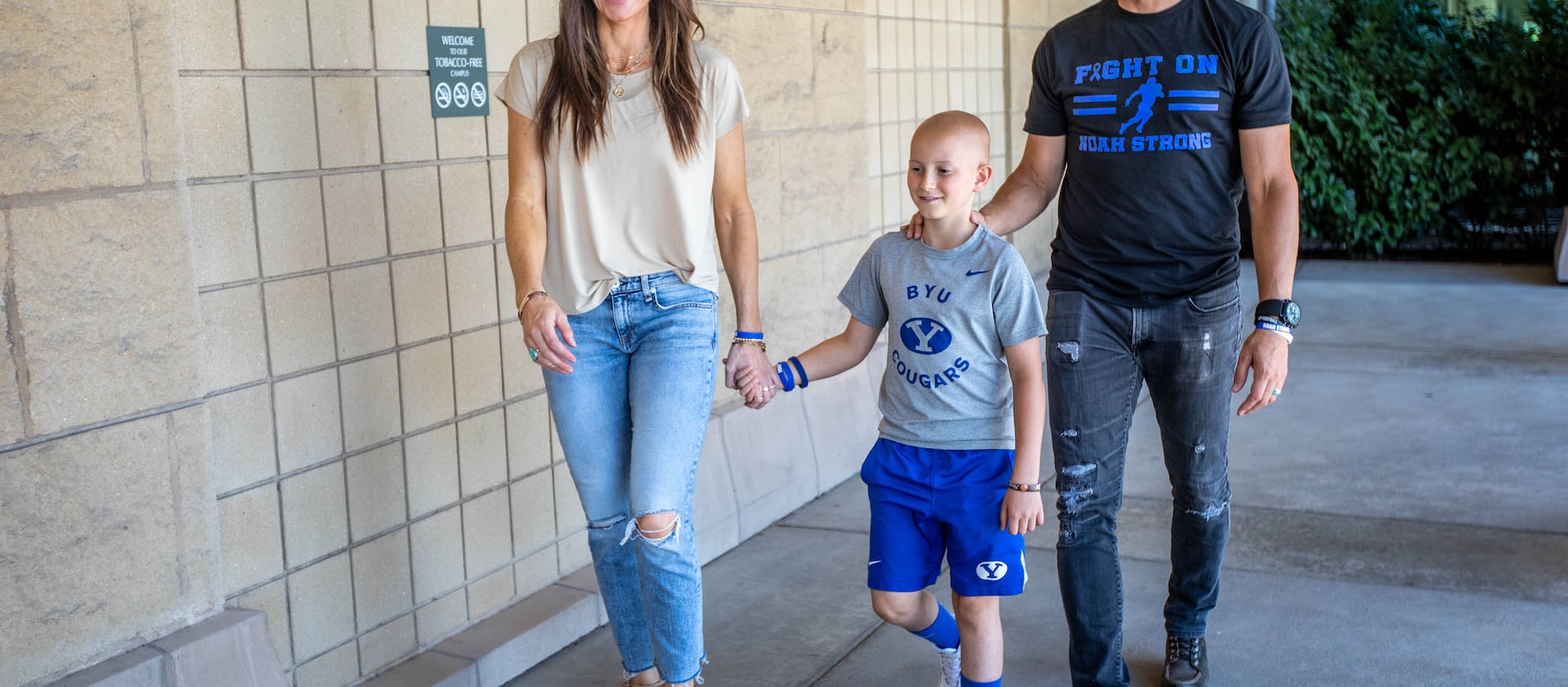 Noah Leeb walks with parents Jacque and James at the Huntsman Cancer Institute in Salt Lake City.