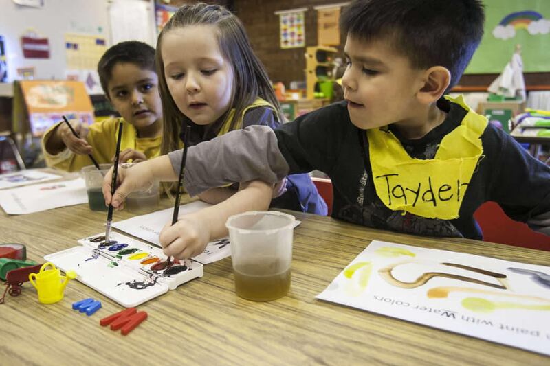 German Duenas-Padilla, Kylee Stauffer and Tayden Larsen work on water color paintings in Aubrey Katyryniuk's preschool class Monday, March 4, 2013 at Calvin Smith Elementary school in Taylorsville.
