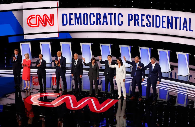 FILE - In this July 31, 2019 file photo, Sen. Michael Bennet, D-Colo., Sen. Kirsten Gillibrand, D-N.Y., former Housing and Urban Development Secretary Julian Castro, Sen. Cory Booker, D-N.J., former Vice President Joe Biden, Sen. Kamala Harris, D-Calif.,