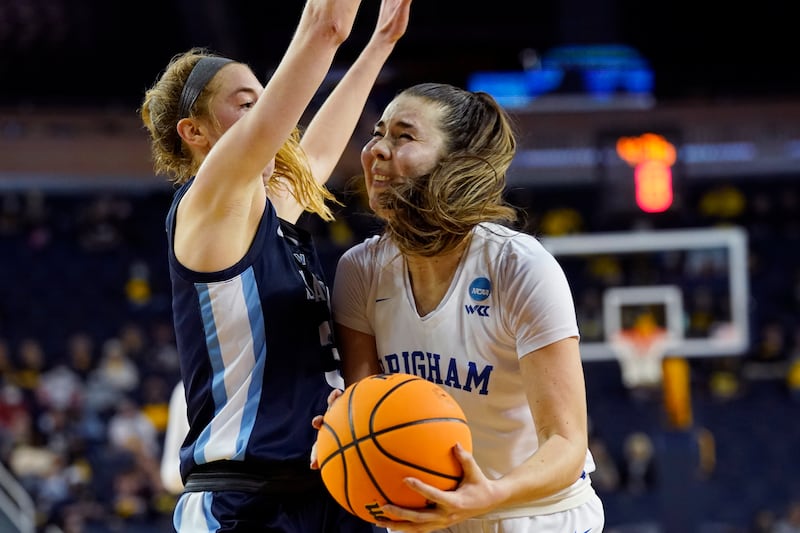 BYU guard Shaylee Gonzales, right, runs into the defense of Villanova guard Lucy Olsen during the second half of a college basketball game in the first round of the NCAA tournament