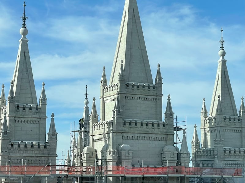 A worker disassembles scaffolding on the central spire of the Salt Lake Temple on Wednesday, Dec. 10, 2025.