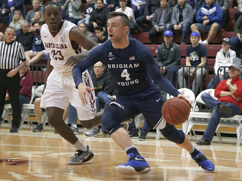 BYU guard Nick Emery (4) drives to the basket against Santa Clara guard Jared Brownridge (23) during the first half of an NCAA college basketball game Thursday, Jan. 26, 2017, in Santa Clara, Calif. (AP Photo/Tony Avelar)