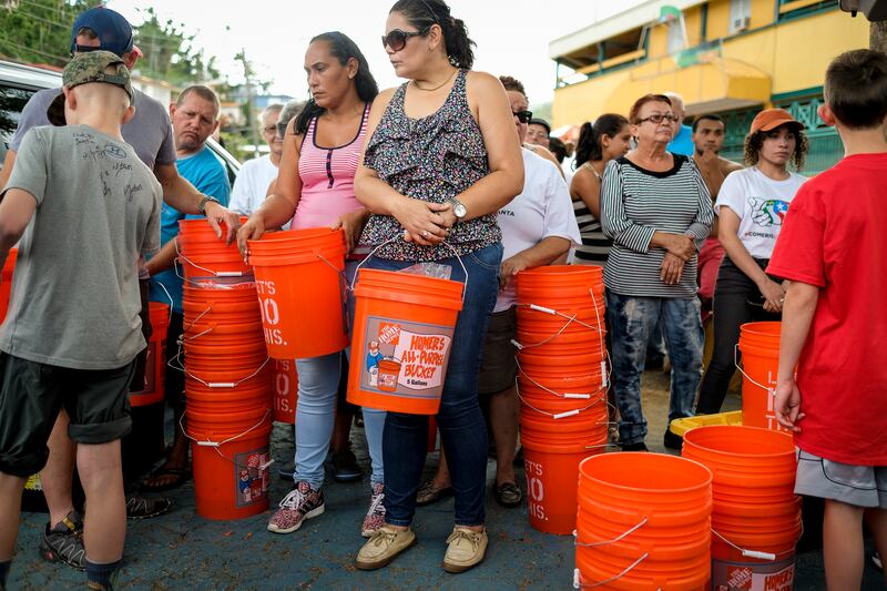 Locals line up to receive water filtration systems and other donations from Light Up Puerto Rico volunteers in Comerío, Puerto Rico, on Friday, Dec. 8, 2017.