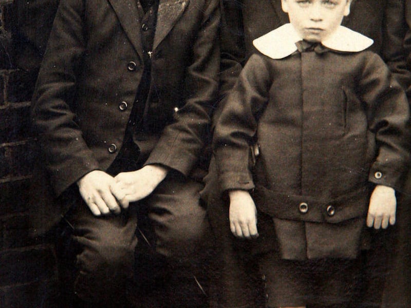 In this Friday, Feb. 4, 2011 photo John Harrison, unseen, a relative of Kate Middleton, shows an image of Kate Middleton's great grandfather Tom, left, in Houghton Le Spring, England. She's not exactly a coal miner's daughter, but Kate Middleton has deep