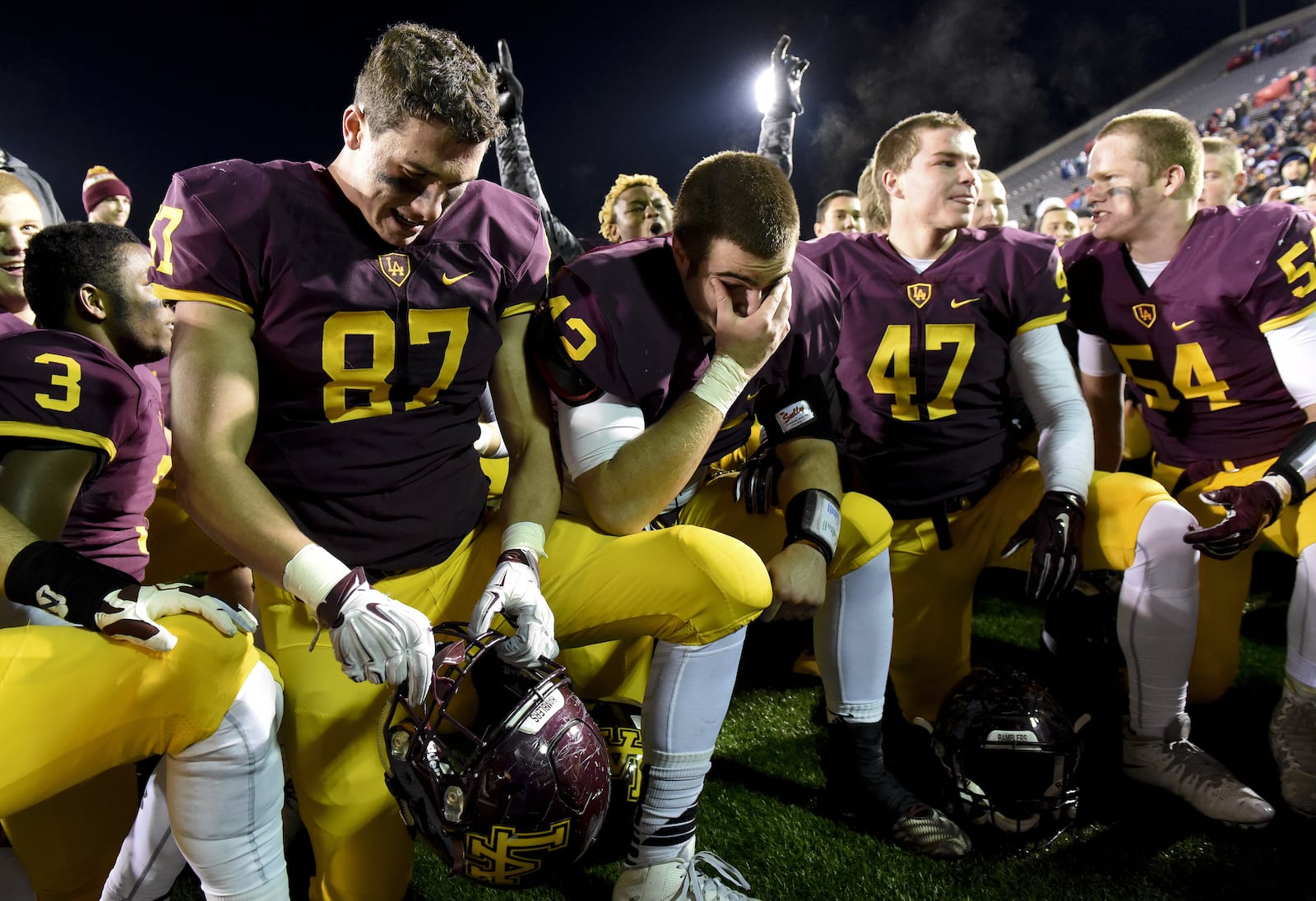 Students at Loyola Academy, a Catholic school in Illinois, pray after winning the 8A high school championship in 2015.