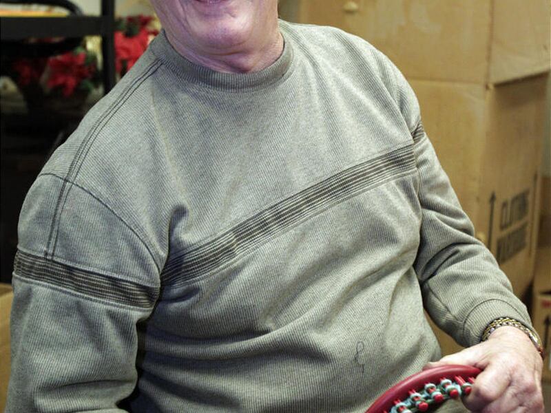 Volunteer Elmer Neitz, 72, jokes with fellow knitters as they work on knitting hats and scarves at the Akron Blind Cente on January 18, 2012, in Akron, Ohio. Center members and volunteers are knitting scarves and hats for people in need. (Mike Cardew/Akro