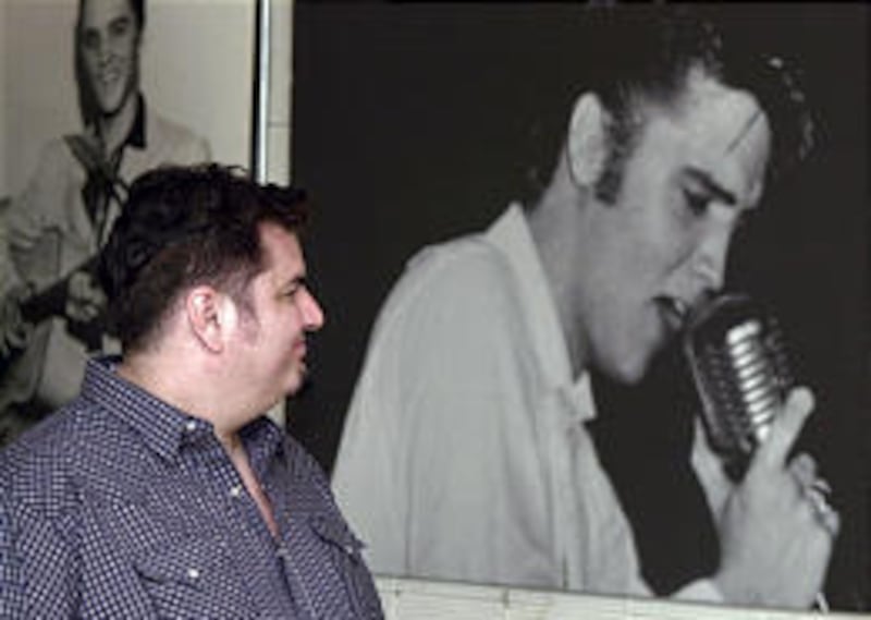 Charles Quinteros of Los Angeles looks at photos of Elvis Presley at Sun Studio in Memphis, Tenn. Presley cut “That’s All Right” in the studio.