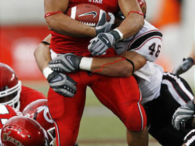 SDSU linebacker Russell Allen wraps up Utah's Darrell Mack for one of his record-setting 22 tackles Saturday.
