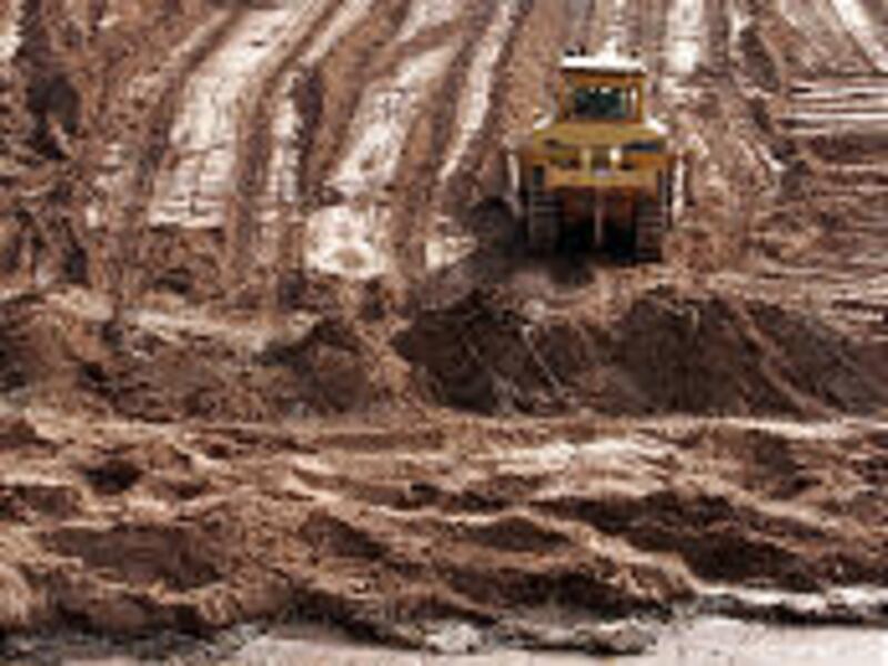 Reconstruction crews work on the banks of the Virgin River in Bloomington. Nearly two dozen homes were destroyed by January's floods.