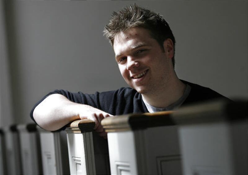Kevin Roose, a Brown University senior and author of "The Unlikely Disciple," sits in the pews of Brown University's campus chapel.
