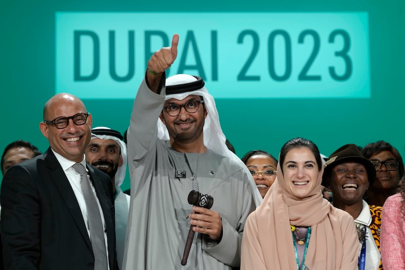 United Nations Climate Chief Simon Stiell, from left, COP28 President Sultan al-Jaber and Hana Al-Hashimi, chief COP28 negotiator for the United Arab Emirates, pose for photos at the COP28 U.N. Climate Summit on Dec. 13, 2023, in Dubai.