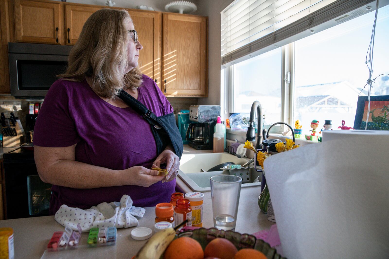 Meg Jackson-Drage watches doves in her backyard in Magna, Utah. Jackson-Drage has joined an effort to make prescription drugs more affordable.