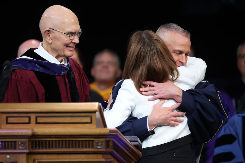 BYU President C. Shane Reese hugs his wife Wendy Reese during his installation as BYU’s 14th president at the Marriott Center in Provo on Sept. 19, 2023.