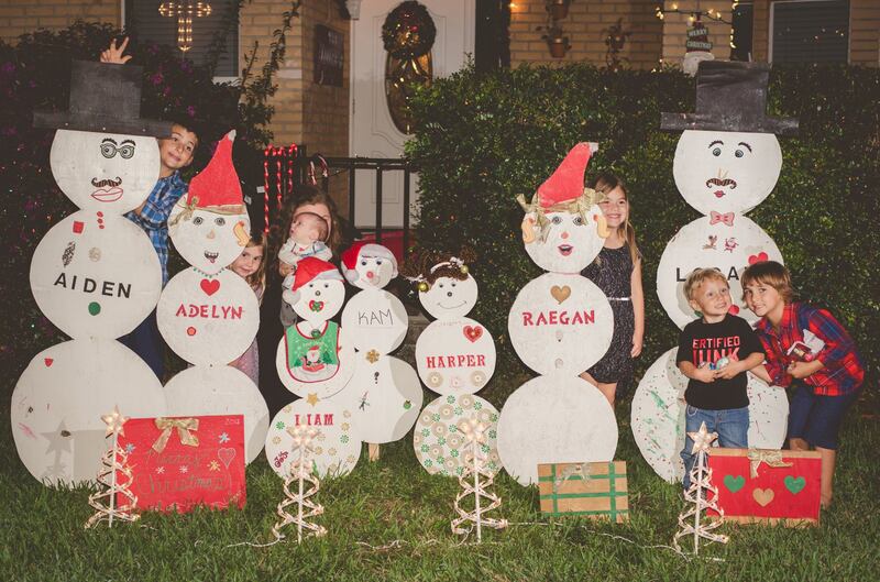 Tate Lindsey Sr.'s snowman decorations list the names of his grandchildren, including his natural grandchildren's half-siblings. He and his wife consider them all theirs, though they're not all biologically related.