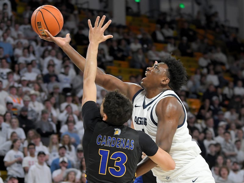 Utah State forward Great Osobor shoots the ball as San Jose State guard Alvaro Cardenas defends