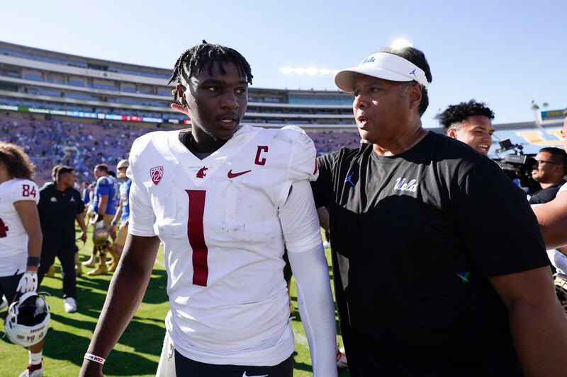 UCLA advisor Ken Niumatalolo, right, greets Washington State QB Cameron Ward after an NCAA college football game.