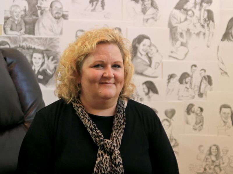 In a May 24, 2016 photo, artist Dotti Durtschi sits in her St. George home with copies of some of the portraits she has drawn through the years. The St. George artist specializes in pencil portraits of people, both living and dead.