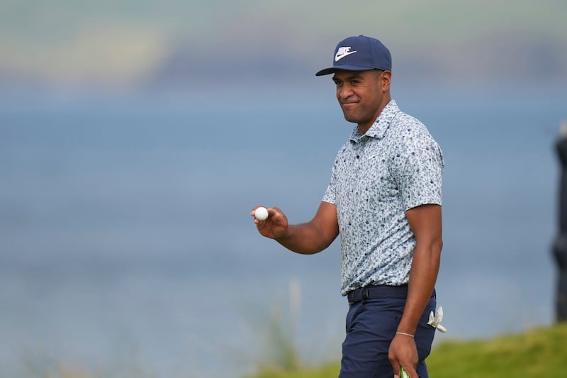 Tony Finau of the United States acknowledges the crowd on the 5th green during the third round of the British Open at the Royal Portrush Golf Club, Northern Ireland, Saturday, July 19, 2025.