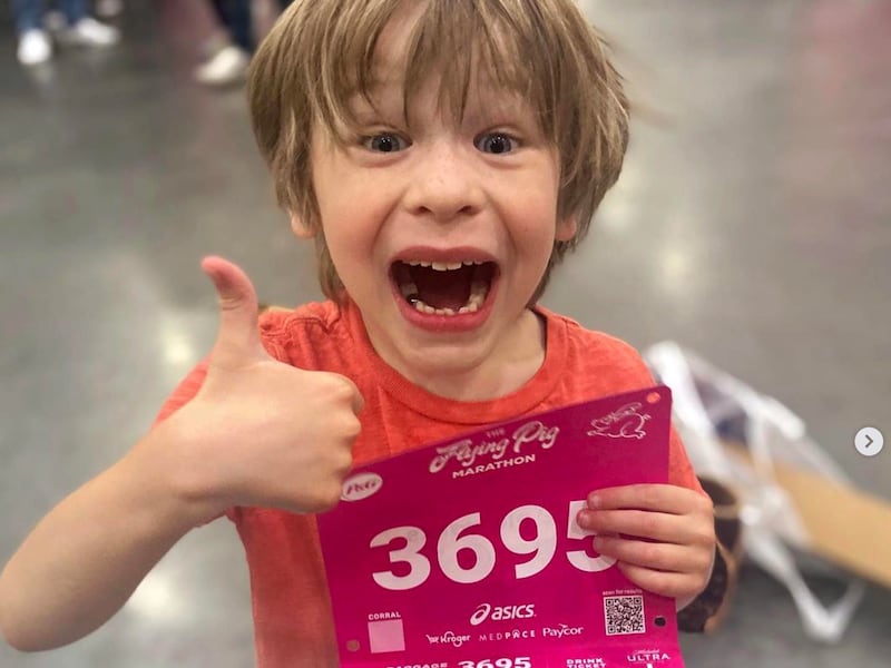 Rainier Crawford, 6, gives a thumbs-up after getting his bib for the Flying Pig Marathon.
