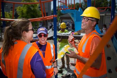Todd Mazza, right, Maggie Bahrmasel and Sarah Branoff laugh and take a break from building a new playground in South Salt Lake on Thursday, Aug. 9, 2018. The playground was based on drawings made by children in the community in June.