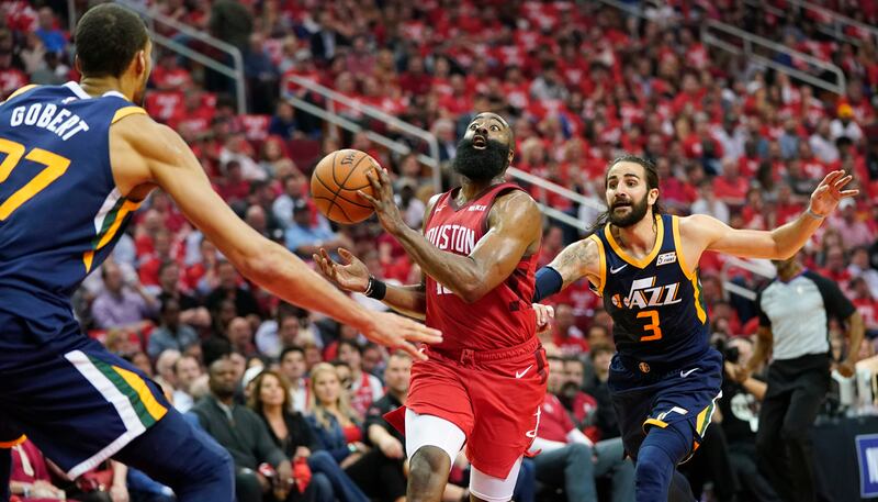 Houston Rockets guard Eric Gordon passes the ball as he drives against Utah Jazz center Rudy Gobert (27) and guard Ricky Rubio (3) during the first half of Game 2 of a first-round NBA basketball playoff series in Houston, Wednesday, April 17, 2019. (AP Ph