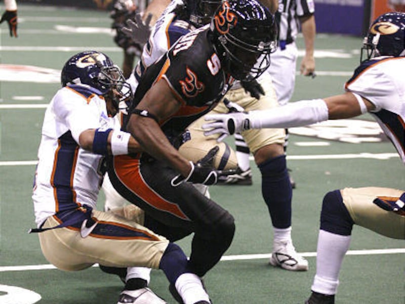Blaze receiver JJ McKelvey is surrounded by a swarm of Colorado players in Saturday's win.