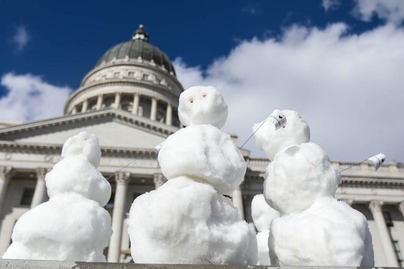 Snowmen were everywhere at the state Capitol in Salt Lake City on Sunday, Feb. 21, 2021. The snowmen appeared outside the building, many holding signs demanding a price on carbon to save their “endangered species.”