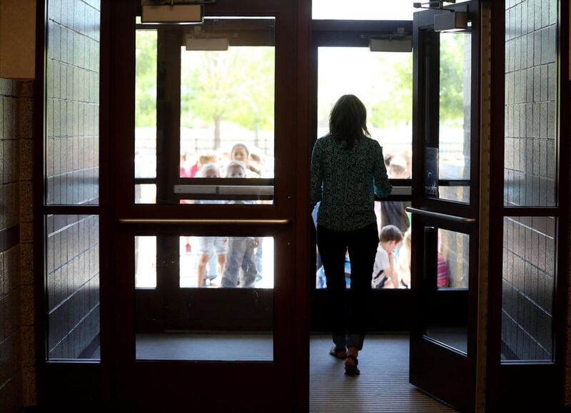 FILE: A first-grade teacher gets her students from recess at South Jordan Elementary School..