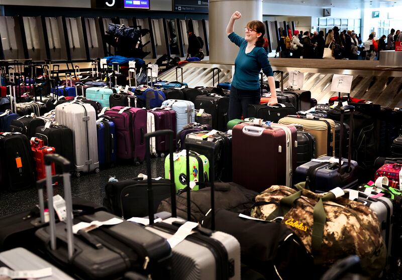 Casandra Friend celebrates finding her luggage at the Southwest Airlines carousel at the Salt Lake airport.