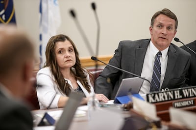 FILE - Granite Board of Education President Karyn H. Winder and Granite School District Superintendent Martin W. Bates talk to other members of the board during a meeting of the Granite Board of Education at the Granite School District offices in South Sa
