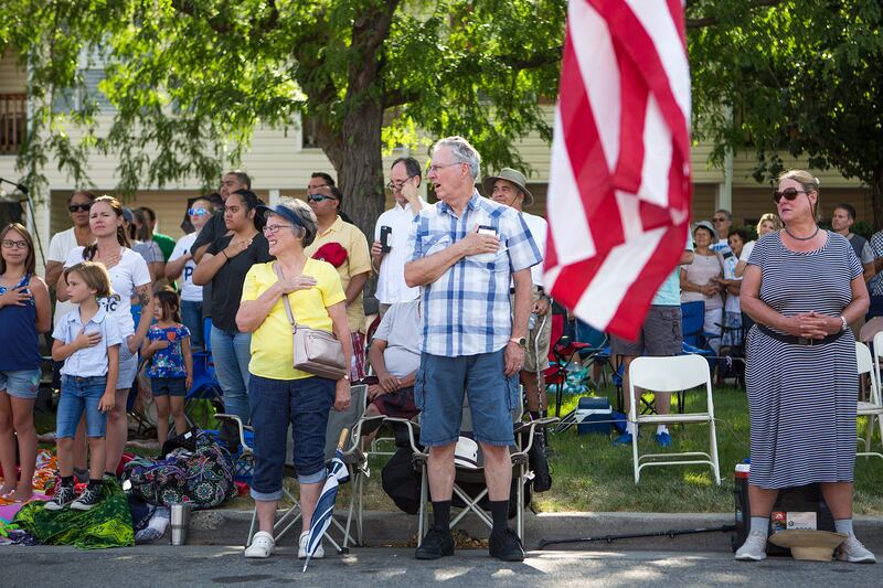 Spectators stand for the passing of Utah Healing Field's American flags during the Days of '47 Parade in Salt Lake City on Tuesday, July 24, 2018.