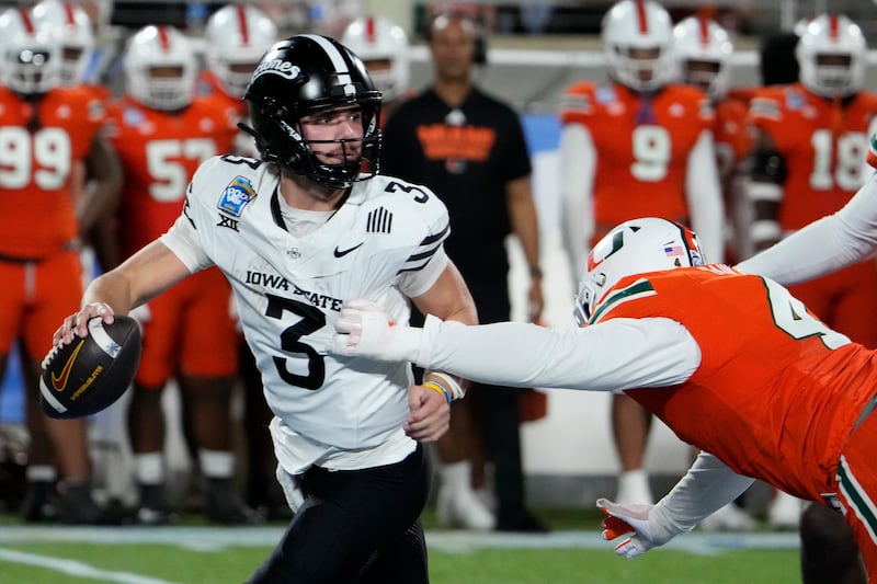 Iowa State quarterback Rocco Becht escapes a sack from Miami defensive lineman Rueben Bain Jr., during the Pop Tarts Bowl Saturday, Dec. 28, 2024, in Orlando, Fla.
