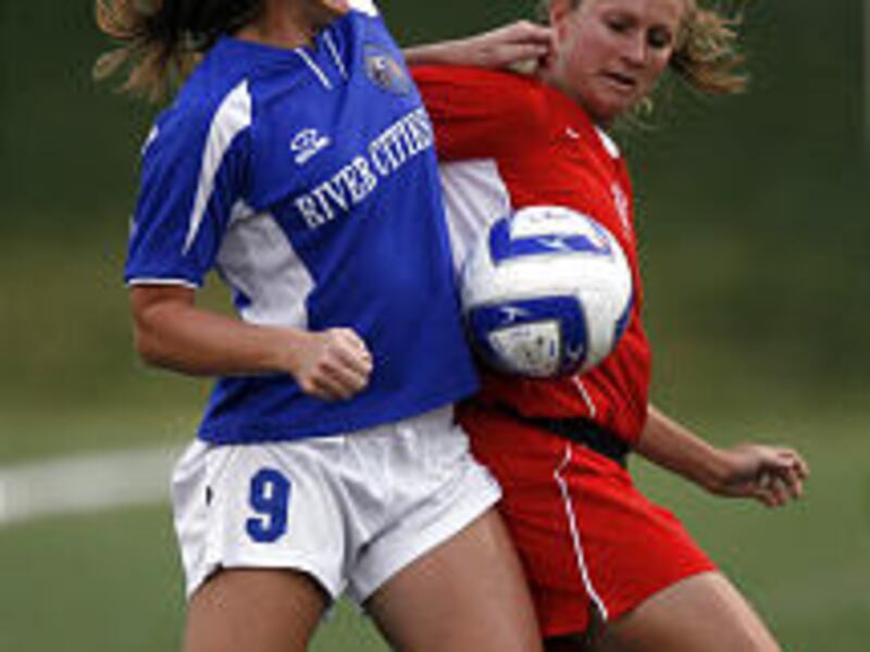 Jennifer Nobis, left, of River Cities and Natalie Franklin of Ajax America fight for the ball during WPSL semifinal play Friday night in Draper. River Cities prevailed in the contest, 2-1.