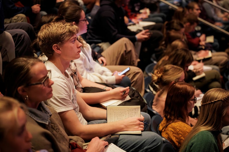 Students listen and take notes as Elder Matthew S. Holland delivers a BYU devotional on Jan. 20, 2026.
