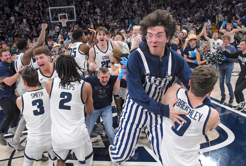Utah State players celebrate with fans after the team’s win over Colorado State in an NCAA college basketball game Saturday, Jan. 6, 2024, in Logan, Utah.