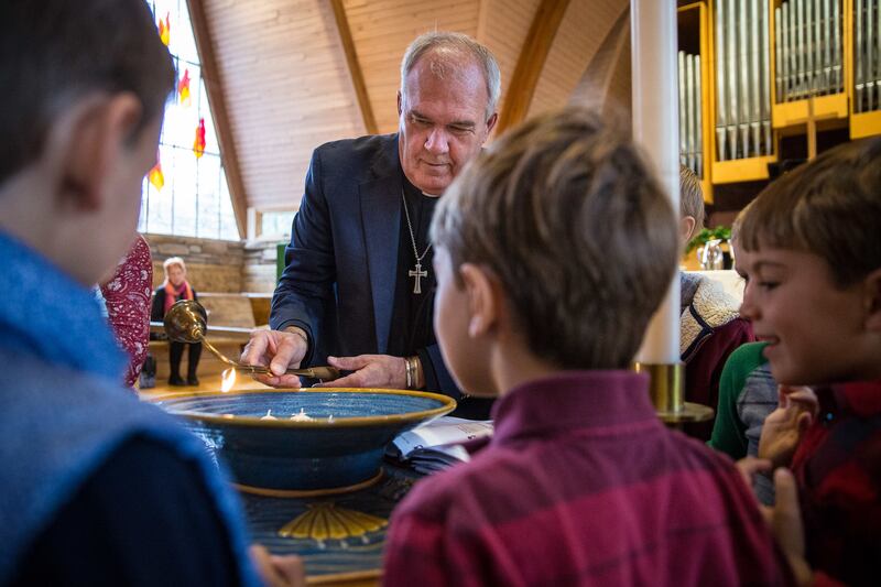 The Rev. Steve Klemz lights the candles to commemorate all the saints at Zion Evangelical Lutheran Church in Salt Lake City on Sunday, Nov. 4, 2018.
