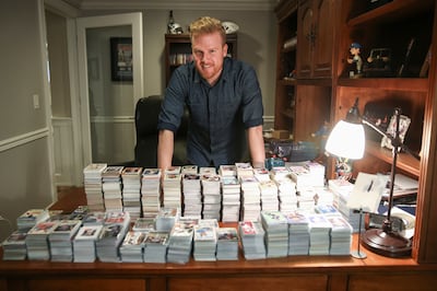 Scott Warner poses for a photo with part of his baseball card collection at his home in Orem on Wednesday, Jan. 24, 2018.