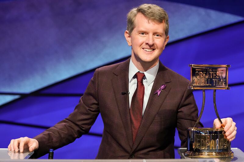 This image released by ABC shows contestant Ken Jennings with a trophy on “Jeopardy! The Greatest of All Time.”