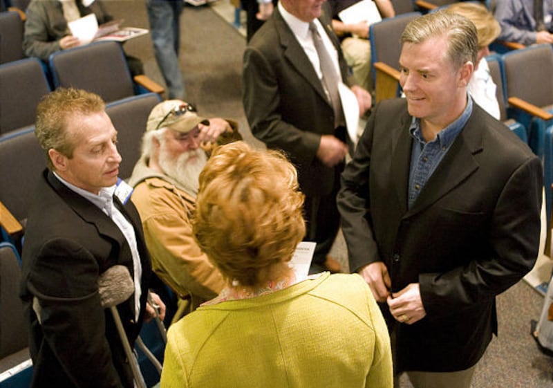 Salt Lake County mayor and gubernatorial candidate Peter Corroon, right, talks with supporters during the Utah County Democratic Convention.