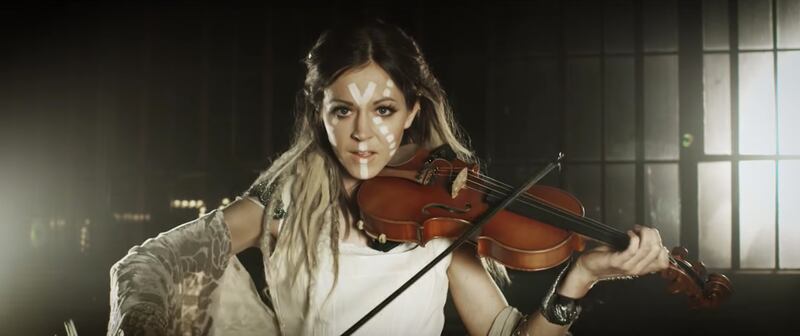 Lindsey Stirling plays the violin in "Stampede," her new music video with Alexander Jean.