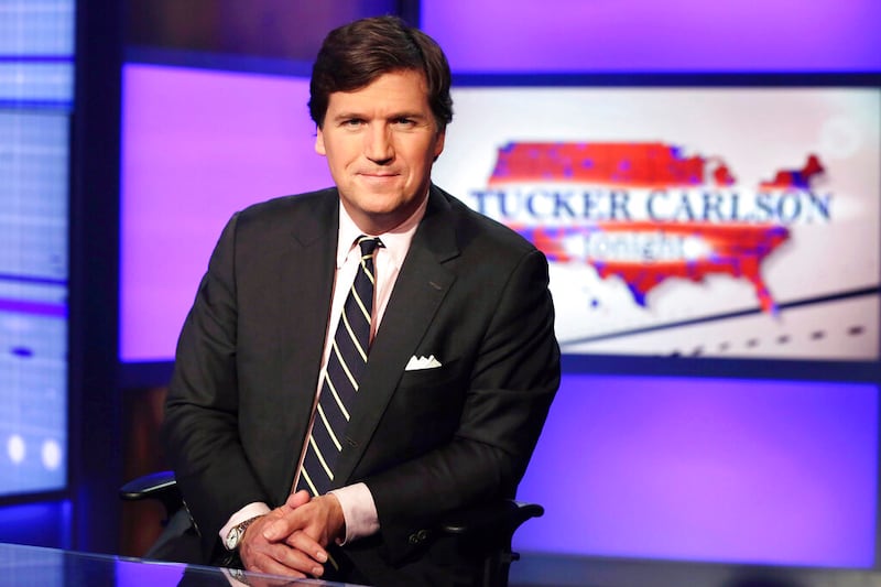 Tucker Carlson, host of “Tucker Carlson Tonight,” poses for photos in a Fox News Channel studio.