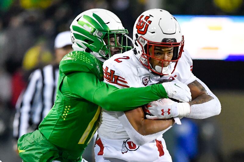Utah running back Micah Bernard is tackled by Oregon defensive back Trikweze Bridges Saturday, Nov. 19, 2022, in Eugene, Ore.