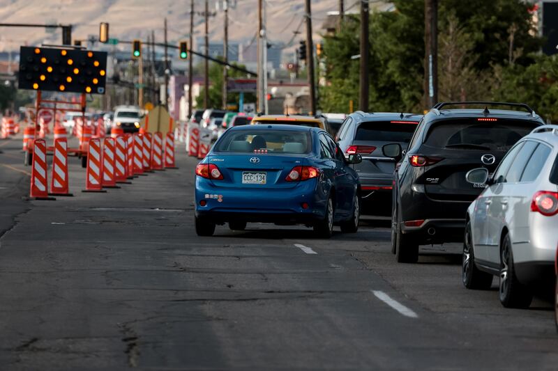 Cars merge due to a temporary lane closure for construction on 300 West in Salt Lake City on Tuesday, July 12, 2022.