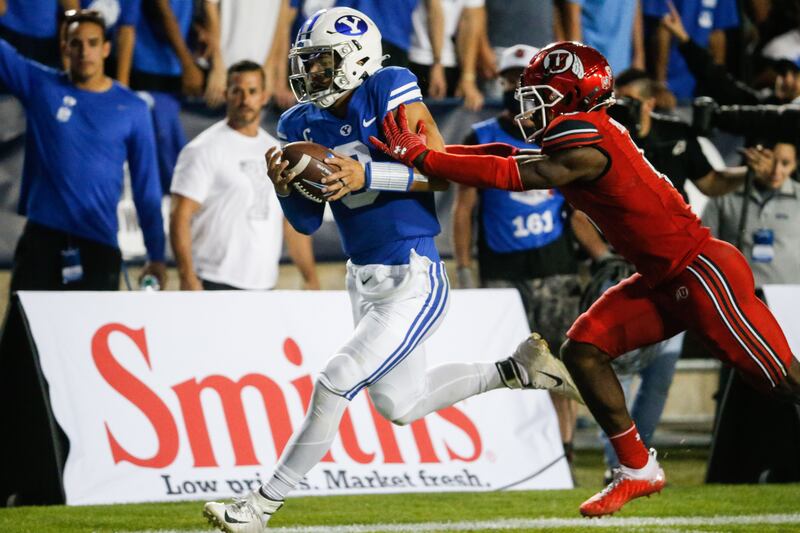 BYU Cougars quarterback Jaren Hall gets pushed by Utah Utes cornerback Clark Phillips III.