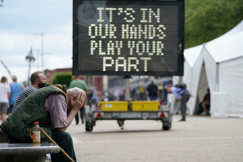 A man waits outside a mobile COVID-19 vaccination center.