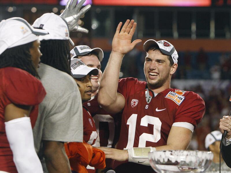 Stanford quarterback Andrew Luck (12) celebrates with teammates after Stanford's 40-12 victory over Virginia Tech in the Orange Bowl NCAA college football game in Miami, Monday, Jan. 3, 2011.