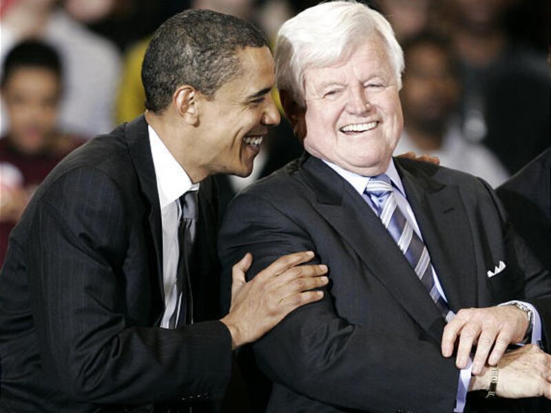 Then Democratic presidential hopeful Sen. Barack Obama, D-Ill., laughs with Sen. Ted Kennedy, D-Mass., during a rally for Obama at American University on Jan. 28, 2008, in Washington, D.C.