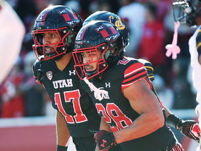 Utah Utes safety Sione Vaki (28) celebrates his touchdown with Utah Utes wide receiver Devaughn Vele (17) against the California Golden Bears in Salt Lake City on Saturday, Oct. 14, 2023. Utah won 34-14.