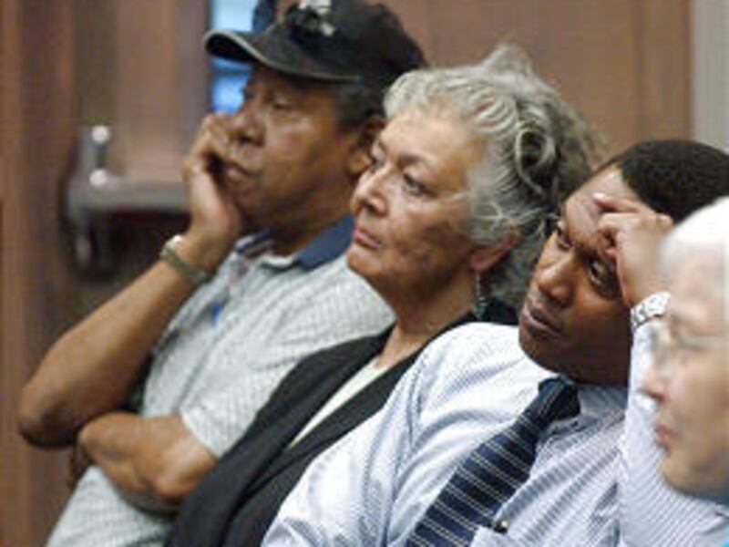 Allen Holmes, left, Kate Hughes and Michael Styles listen Monday to the candidates at the NAACP "Meet the Candidates Forum."